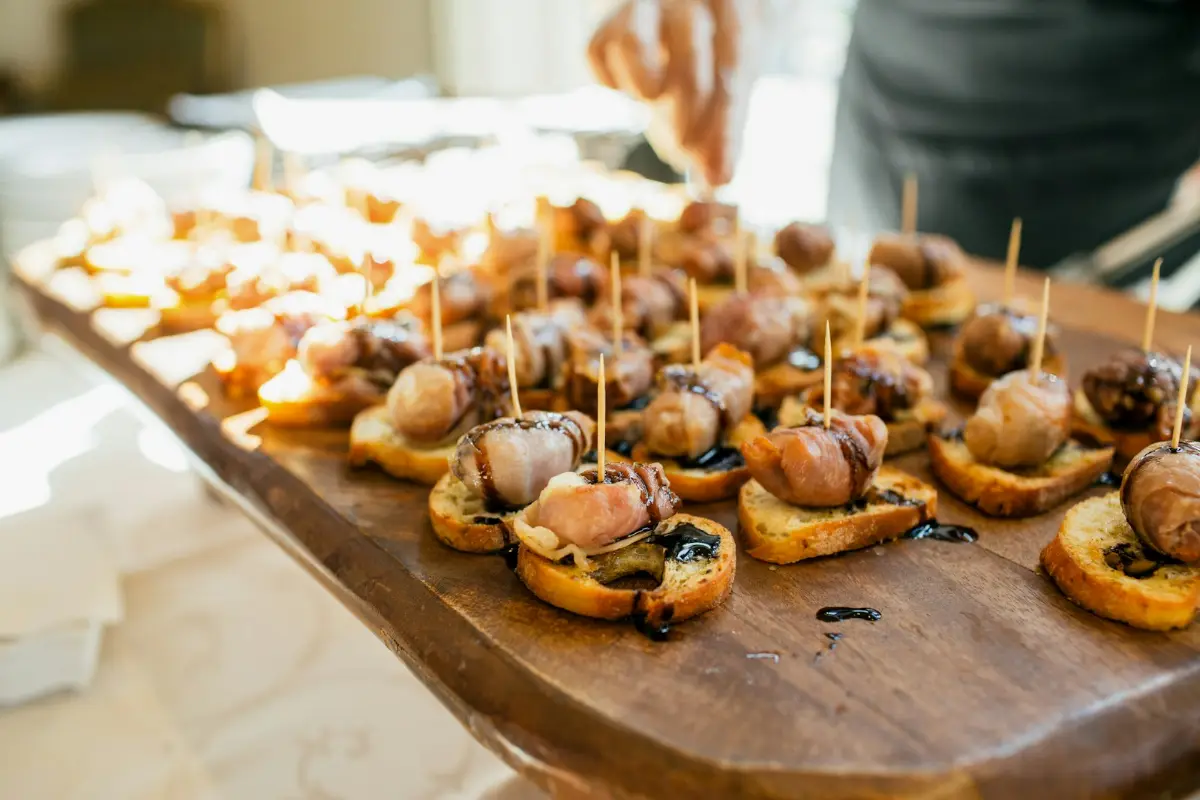 Small canapés on a long wooden serving board